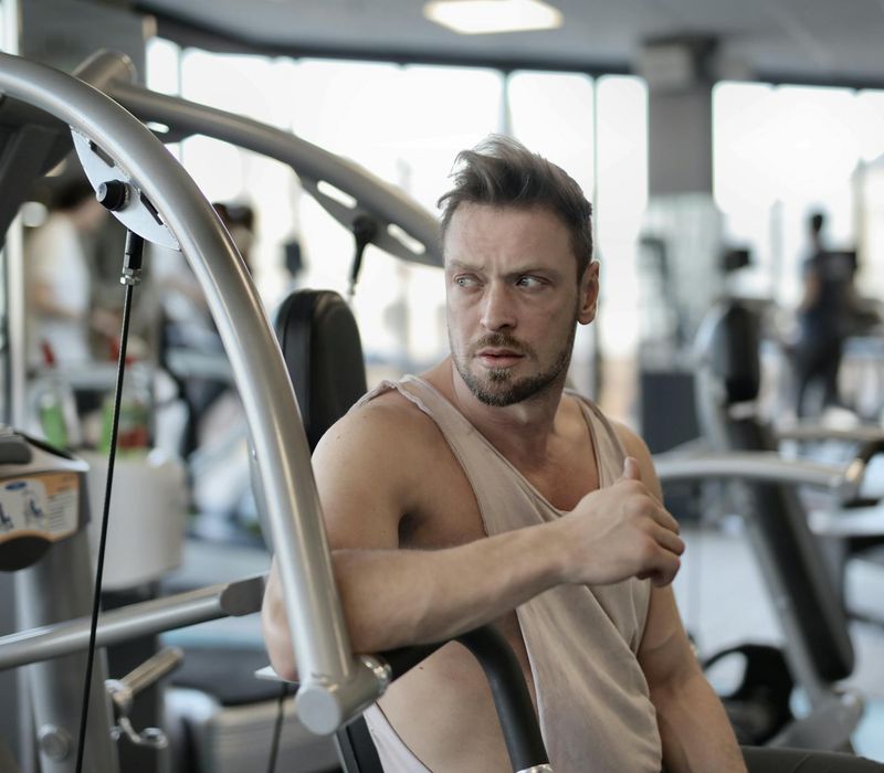 Man looking determined and focused during a workout break.